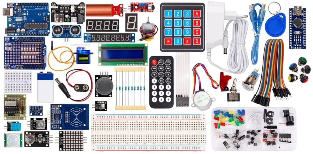 An electronics kit laid out: microcontroller boards, sensors, a keypad, a display and wiring